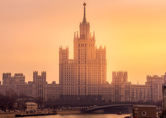 Fototapeta na wymiar View at Kotelnicheskaya Embankment Building and Moskva River, during beautiful golden sunrise, Moscow, Russia
