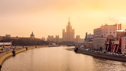Fototapeta na wymiar Panoramic cityscape with view at Kotelnicheskaya Embankment Building and Moskva River, during beautiful golden sunrise, Moscow, Russia