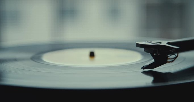 Vinyl start. Close up on turntable stylus going down. 