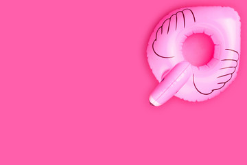Summer concept. Inflatable pink flamingo isolated on pink background. 