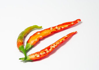 Organic Red and Green Cayenne pepper on a white background