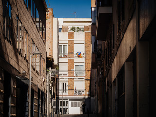 Fototapeta na wymiar Catalan flag hanged on a balcony of apartment building in Barcelona