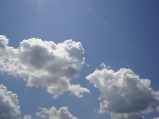 Fluffy White Clouds In Blue Sky Background