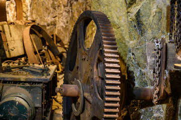 Abandoned gears and equipment inside a closed gold mine
