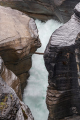 An alpine river cutting into rocks creating a channel. The Rocky Mountains, Canada.