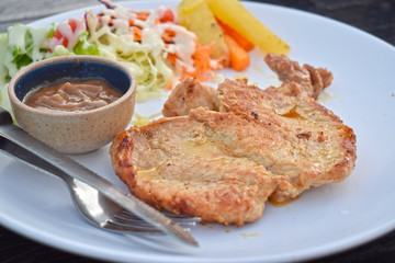  Pork steak with vegetable salads and sauces is a delicious and popular dish.