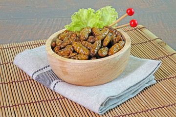 Edible insects : Deep fried crispy Silkworm pupae.  Entomophagy : Edible insects, other natural sources of nutrients. Famous street food in Thailand. Copy space