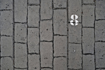 Obraz premium 8, number eight, white stencil number on cobblestone surface.