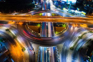Fototapeta na wymiar Aerial view night roundabount traffic road with car light movement