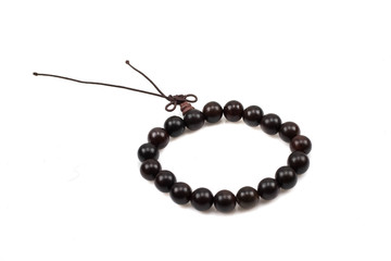 A close up image of dark wood bead bracelets isoalted on a white background