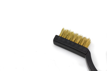 A close up image of a wire brush, shot in macro against a white background with space for text