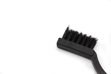 A close up image of a wire brush, shot in macro against a white background with space for text