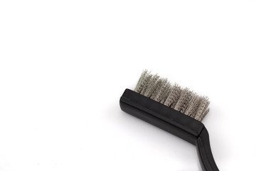 A close up image of a wire brush, shot in macro against a white background with space for text
