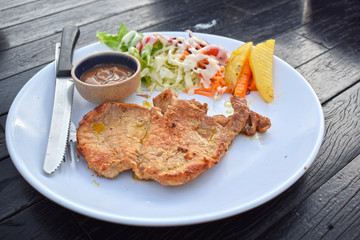  Pork steak with vegetable salads and sauces is a delicious and popular dish.