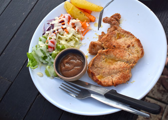  Pork steak with vegetable salads and sauces is a delicious and popular dish.