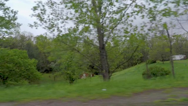 POV driving by manufactured homes one with a confederate flag in the spring