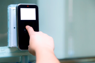 Close up of the hand are scanning on fingerprint machine for enter digital security door system in the office building at Bangkok ,Thailand.