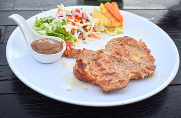  Pork steak with vegetable salads and sauces is a delicious and popular dish.