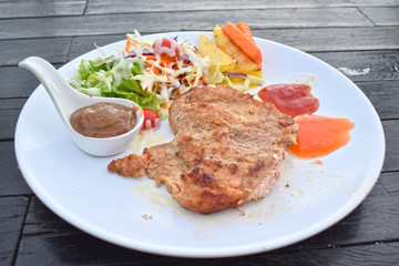  Pork steak with vegetable salads and sauces is a delicious and popular dish.