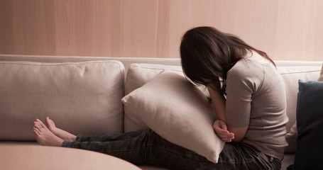woman feel depressed on sofa