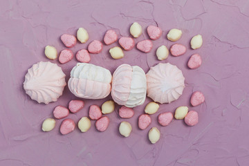 Marshmallows on pink background. Colorful marshmallow sweets with copy space