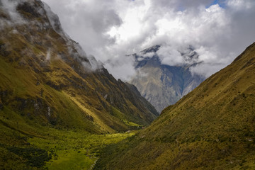 Fototapeta premium Dark green valleys dominates the landscapes around the Inca trail on this fog and overcast day in Peru