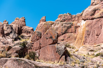Fototapeta na wymiar Brown and dry rock formation that look like small mountains on clear and Sunday in Portal de Aramu Muru, Peru.