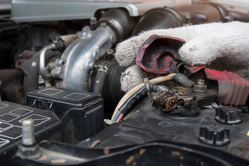 Fix car a wrench on hand with engine car on background.