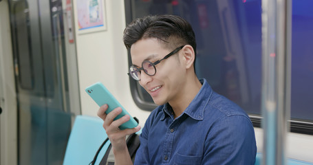 Naklejka na ściany i meble man use phone in MRT