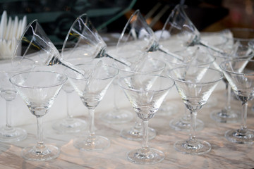 Many of glass for wine in row on table