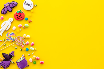 Creepy cookies for halloween treat frame on yellow background top view mockup