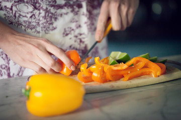 Closeup of woman hands, chopping sweet peppers