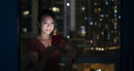 Woman use of mobile phone at night