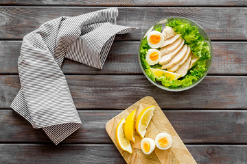 Salad bowl with healthy food on wooden background top view