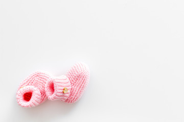 Booties for newborn girl on white background top view mock up