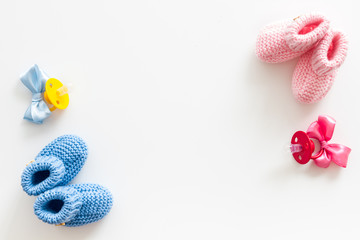 Blue and pink knitted footwear for kids, dummy on white background top view space for text