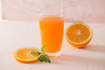 Isolated orange juice with slices of oranges on white background. 100 percent fresh and organic. Sweet juicy cocktail in glass. Natural antioxidant.