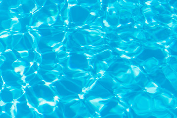 Blue pool water with sun reflections