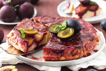Caramelised plum upside-down cake on a white plate