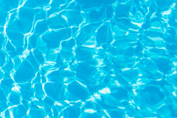 Blue pool water with sun reflections