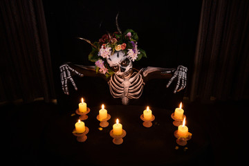 Halloween, Day of the dead Ghost doing superstition voodoo with candle lights in the dark room