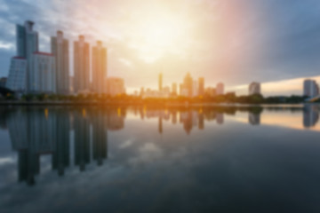 Blur City building with water reflection before sunset