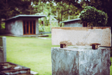 Fototapeta premium Empty sign made of wood on the cement pole on garden background.