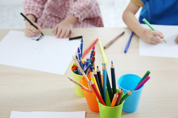 Together Asian preschool student do homework by drawing by a color, this image can use for group study, school, kid, student and education concept.