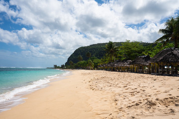 Fototapeta na wymiar Beach fale's on a white sand beach on Lalomanu, Samoa