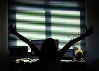 silhouette of a woman working in a home office - social media influence, blogger, vlogger, freedom