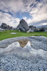 Castle Hill New Zealand with large rocks blue sky reflection