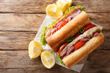 Hearty delicious turkish sandwich balik emek with grilled mackerel served with lemon closeup. Horizontal top view