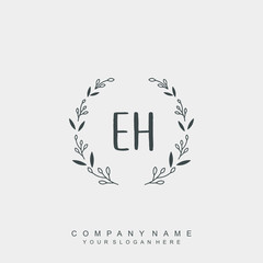 letter EH surrounded by beautiful and elegant flowers and leaves. Wedding monogram logo template.