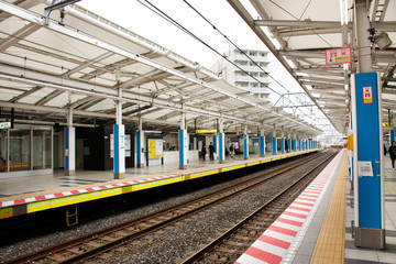 Japanese people and foreign traveler passengers wait and walking up and down journey with MRT Tozai Line trains go to Ginza at Kasai Station in Tokyo, Japan